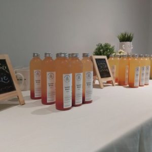 Antidote juice bottles lined up on a table for a corporate event