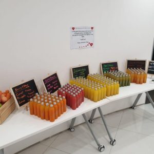 antidote juice bottles displayed at a corporate event