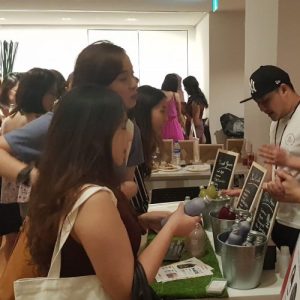 two ladies looking at antidote juice products at a physical booth