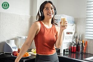 Woman enjoying a healthy smoothie for better gut health.