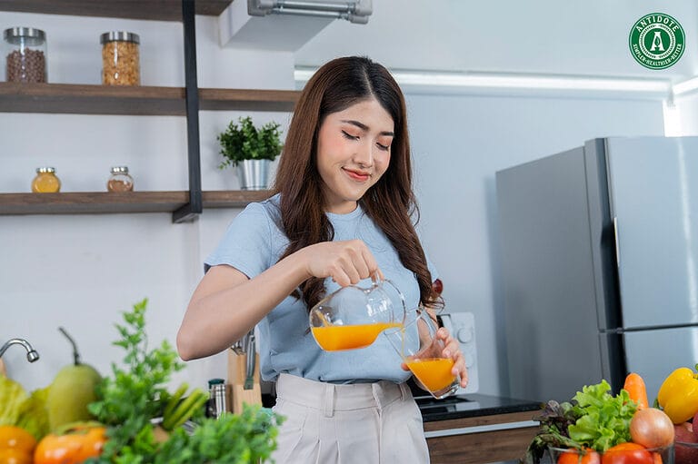 Woman pouring fresh juice to curb cravings.